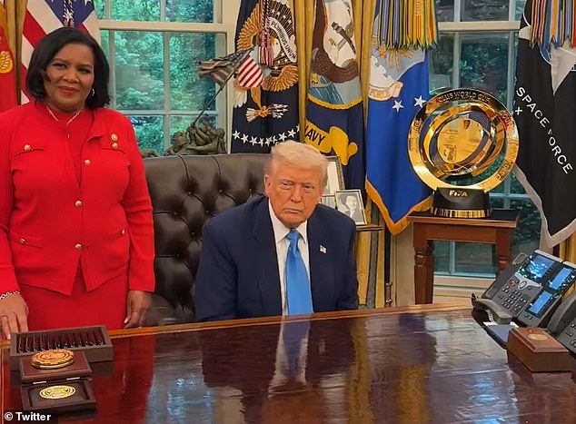 President Donald Trump is captured in the Oval Office on Tuesday on a call with Savannah Chrisley and her younger brother informing him of his decision to pardon parents Todd and Julie. Alice Marie Johnson (left) who Trump pardoned during his first term, stood beside him
