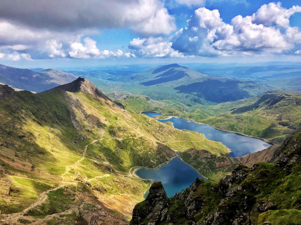 View from Snowdon peak over lakes and mountains in Snowdonia National Park.