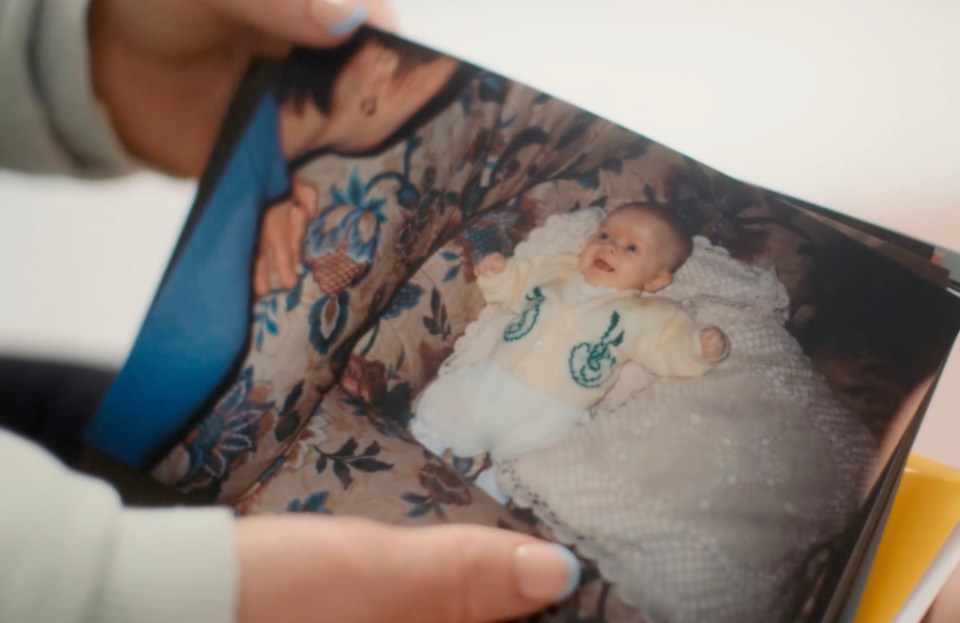 Person holding a baby photo.