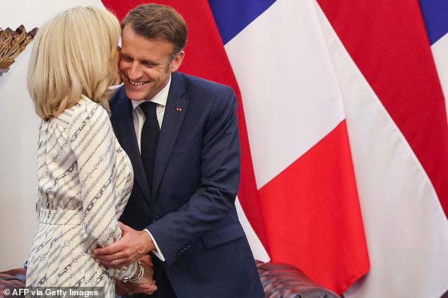 Macron's communications team were overwhelmed by the furore triggered by the video and tried to claim it was an AI-generated fake before admitting it was genuine just hours later Pictured: Brigitte Macron kisses her husband's face as they received by Indonesia's President Prabowo Subianto at Merdeka Palace today