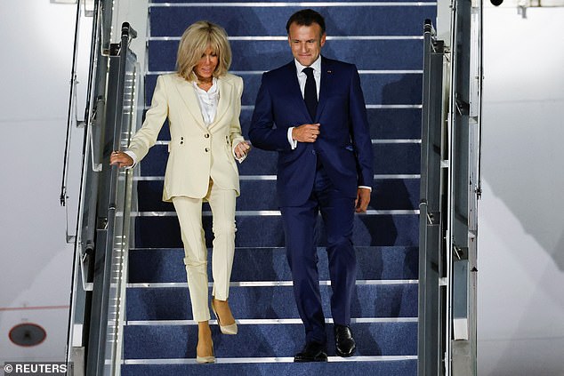 French President Emmanuel Macron and his wife, Brigitte Macron disembarks from the plane upon their arrival at military airbase Halim Perdanakusuma in Jakarta, Indonesia