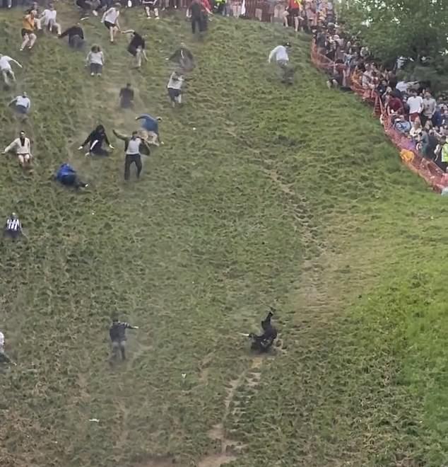Members of the crowd looked on in horror - but it is believed the man managed to escape without breaking any bones
