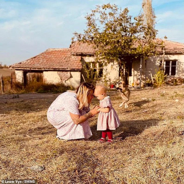 Jordan Vye pictured with daughter Fae outside their Bulgarian farmhouse