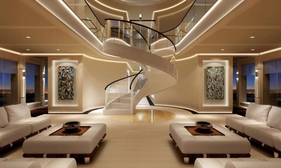 Interior of the Pi superyacht, featuring a spiral staircase and seating area.