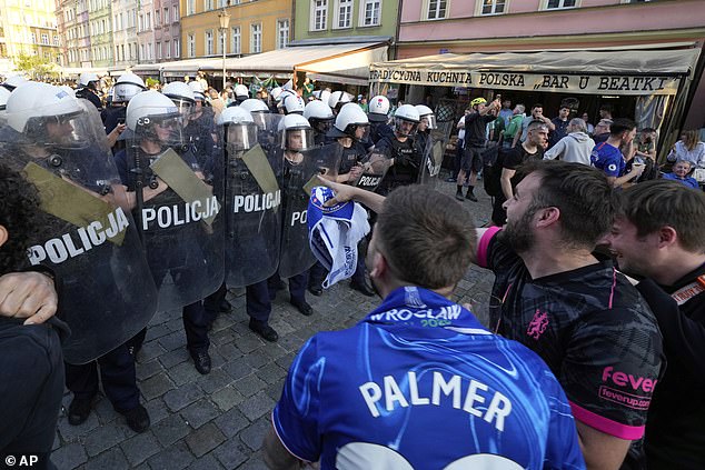 Armed police created a barricade in Market Square to try defuse clashes between fans