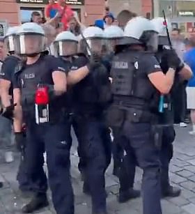 Another video shows police pushing fans back and prepare to pepper spray them