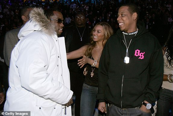 DENVER - FEBRUARY 20:  Sean 'P Diddy' Combs talks with Beyonce Knowles and Jay Z after  the 2005 NBA All Star Game at the Pepsi Center on February 20, 2005 in Denver, Colorado.   (Photo by Mark Mainz/Getty Images)