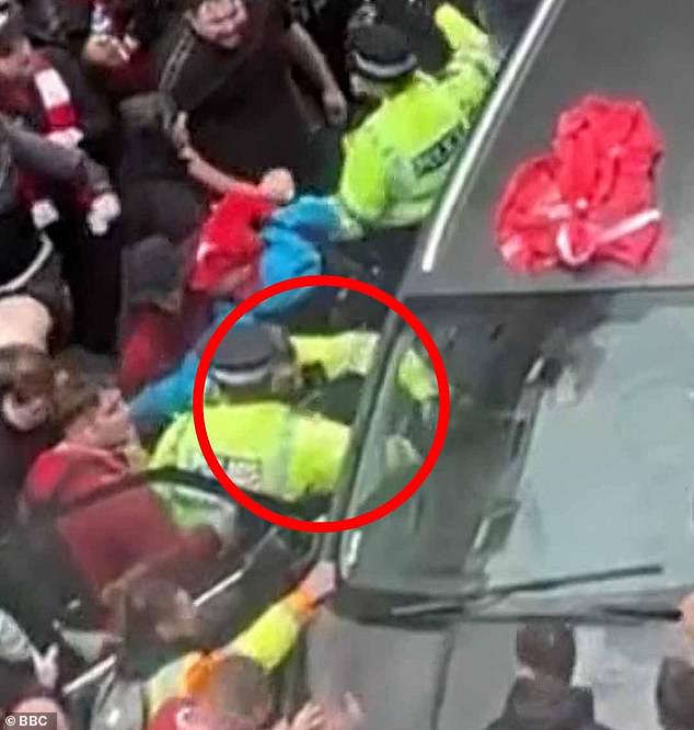 Police pull the 53-year-old driver out of the car after it ploughed through the crowd on Water Street