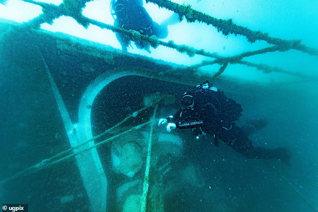 Italian coastguard divers swim past the starboard bulkhead in the first images from the wreck of the Bayesian