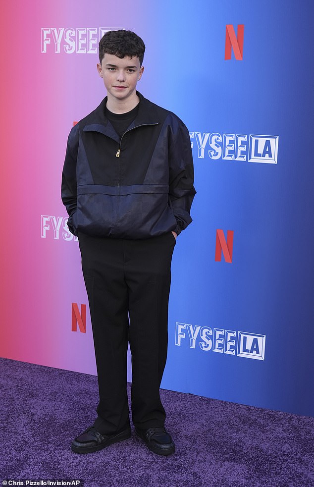 The man of the moment looked dapper for the occasion in a pair of black suit trousers and a navy and black jacket