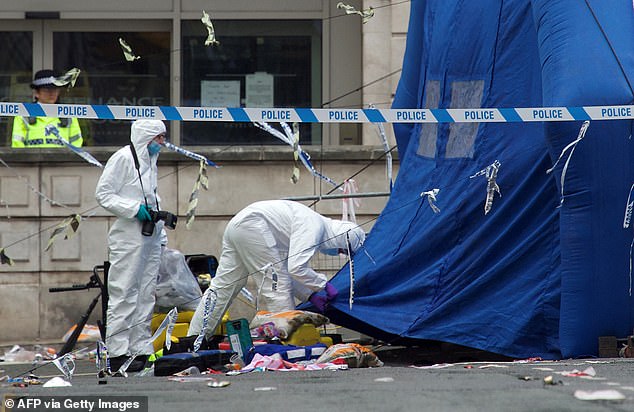 Police forensics officers work at the scene on Water Street in Liverpool, north-west England on May 27, 2025, where a car ploughed in to crowds that had gathered