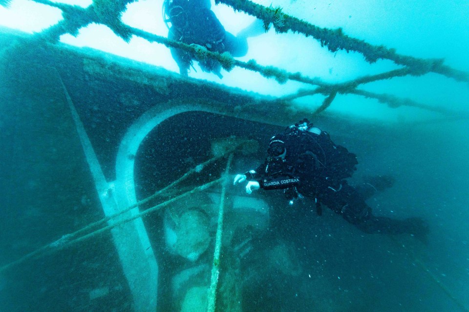Divers exploring the sunken Bayesian yacht.