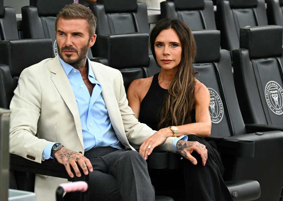 David and Victoria Beckham seated together at a sporting event.
