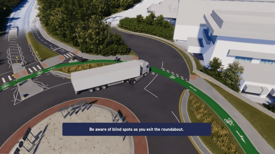 Illustration of a truck exiting a roundabout, highlighting blind spots.