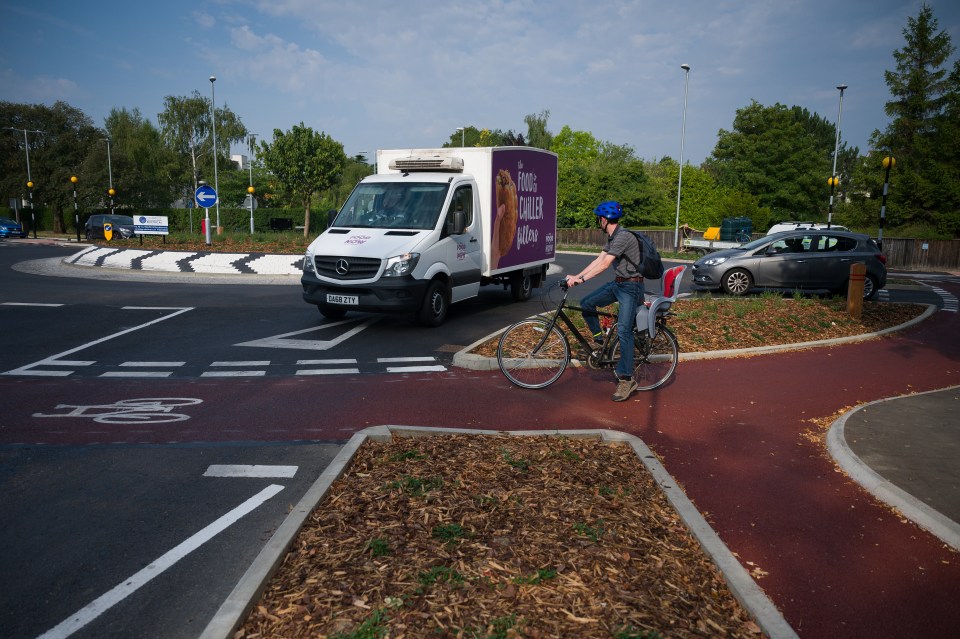 Cyclist on a new UK cycle-friendly roundabout.