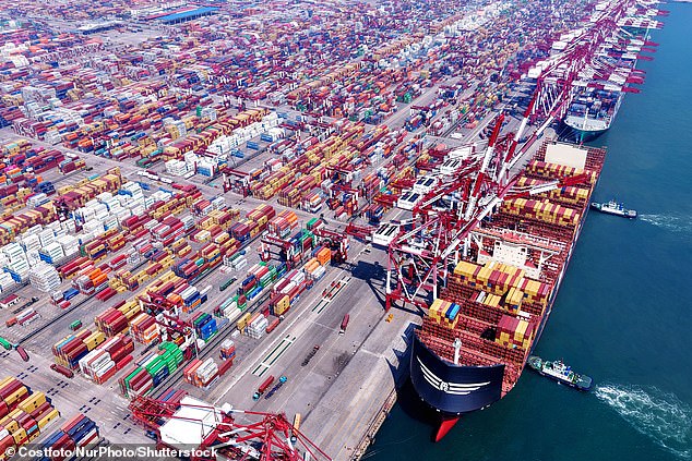 A cargo ship loads and unloads foreign trade containers at Qingdao Port in China
