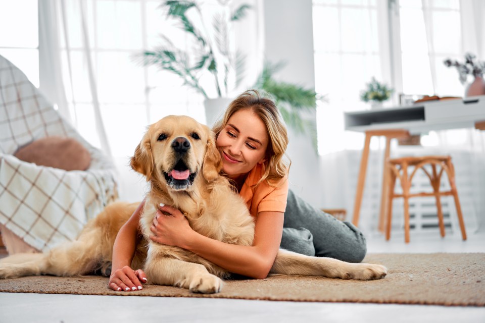 Woman hugging her Golden Retriever.