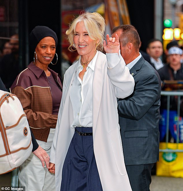Her platinum blonde hair was elegantly swept into an updo, with a few strands softly framing her radiant face