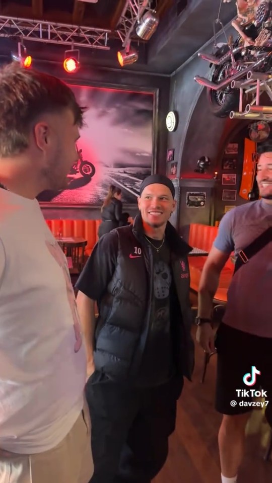 Mykhailo Mudryk in a Chelsea kit at a bar.