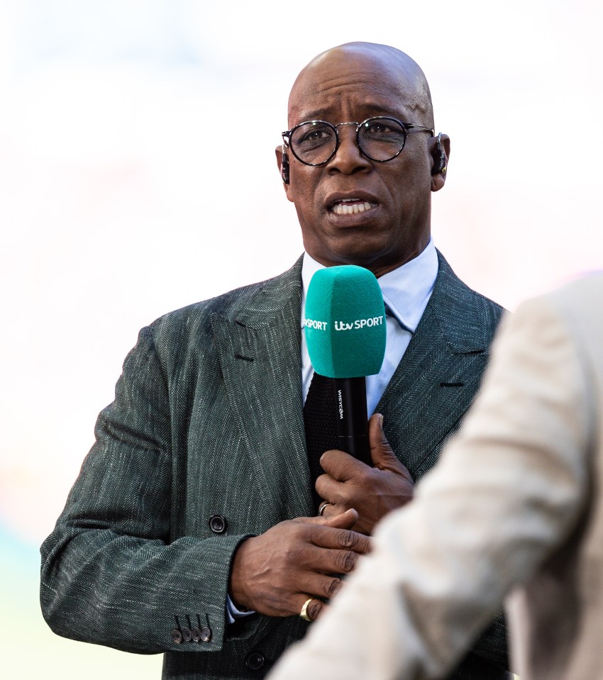 Ian Wright speaking into a microphone.