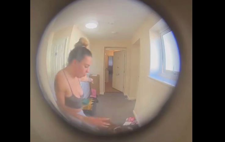 Doorbell camera still image showing a woman in a hallway.
