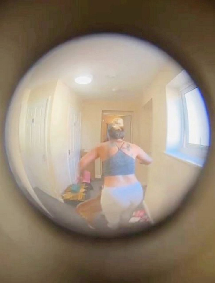 Doorbell camera footage of a woman walking down a hallway.