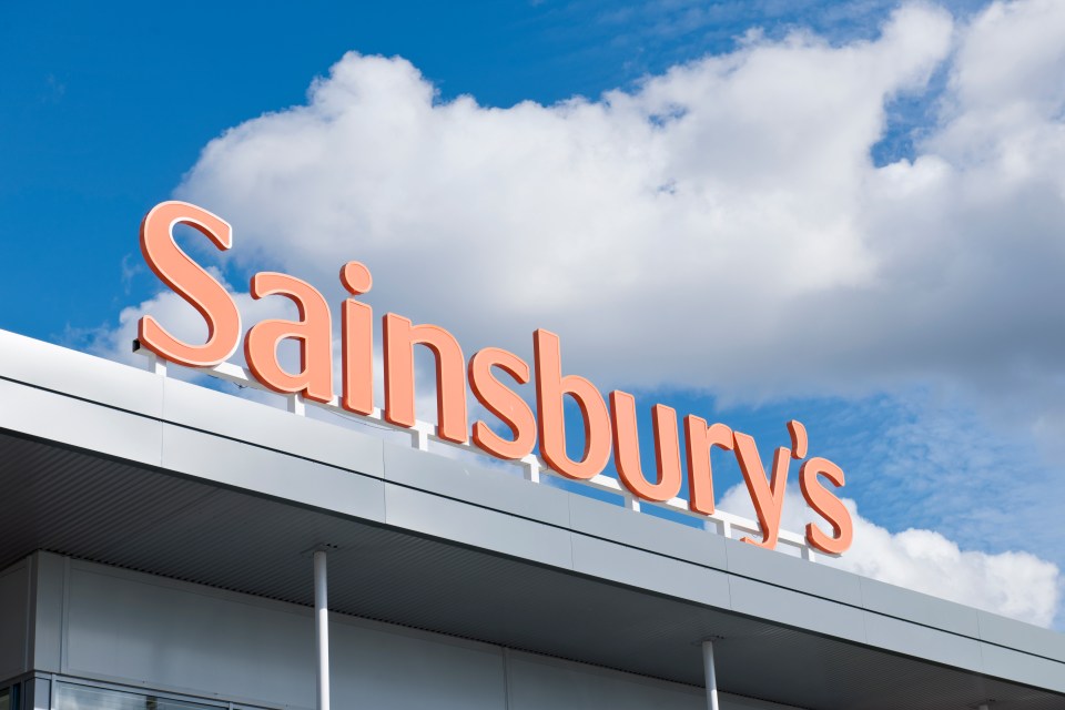 Large Sainsbury's supermarket sign on a building.