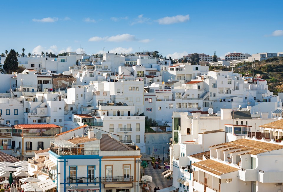 Aerial view of Albufeira, Portugal, showing whitewashed buildings under a sunny sky.