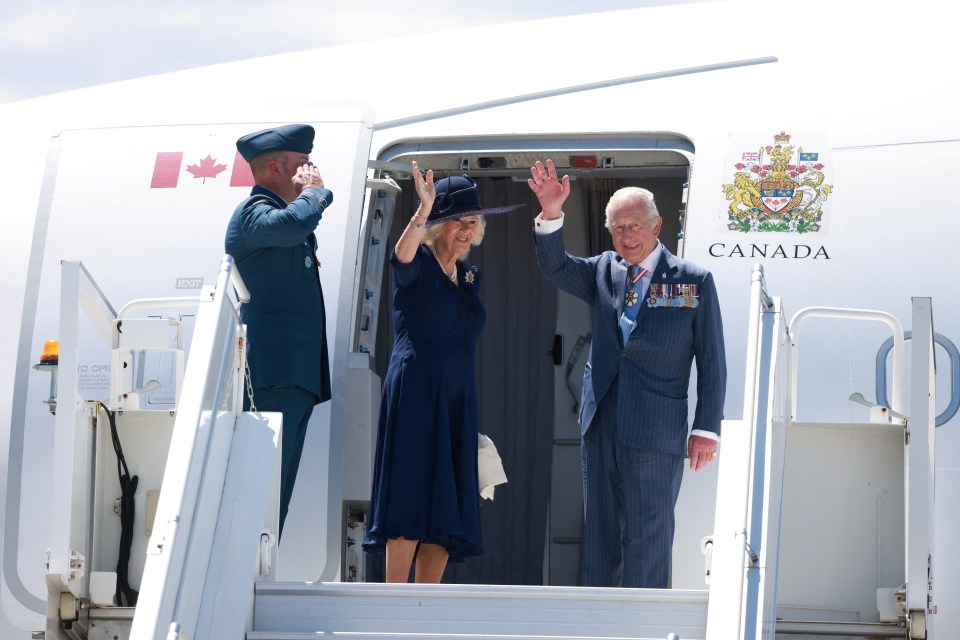 King Charles III and Queen Camilla waving goodbye as they depart from a plane in Canada.