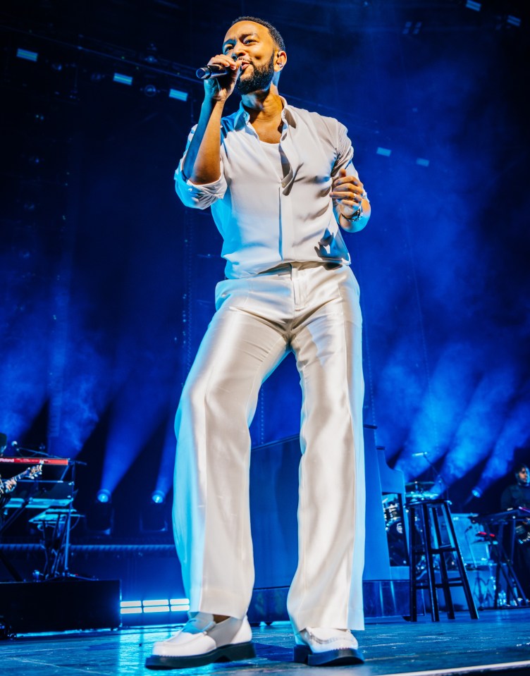 John Legend performing on stage.