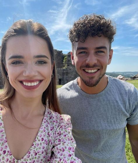 Caroline Koziol and a man smiling for a selfie.