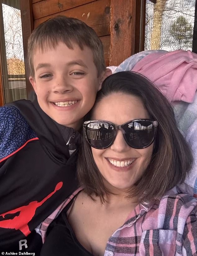 His mother Ashlee (pictured together) said she felt 'indescribable pain' as she lay with Liam during his final moments and the medical team turned off his life support