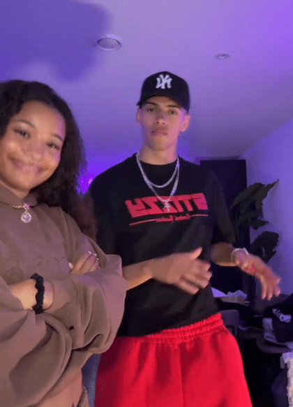 Young man and woman posing indoors.