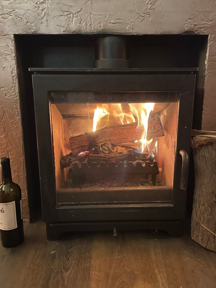Fire burning in a wood-burning stove.