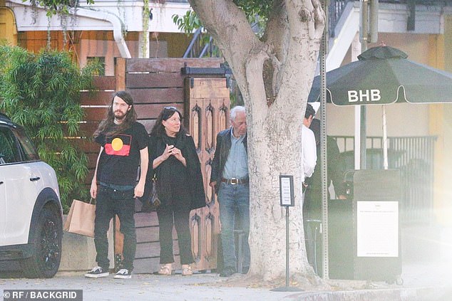 Linda looked youthful with shoulder-length brunette locks as she arrived for dinner at a Los Angeles restaurant in black trousers, a matching black top, and a shawl wrapped around her neck