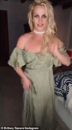 Spears also twirled for the camera before crouching down towards the floor and also fell backwards onto the bed