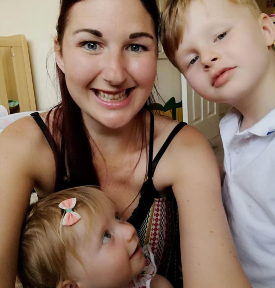A woman with two young children.