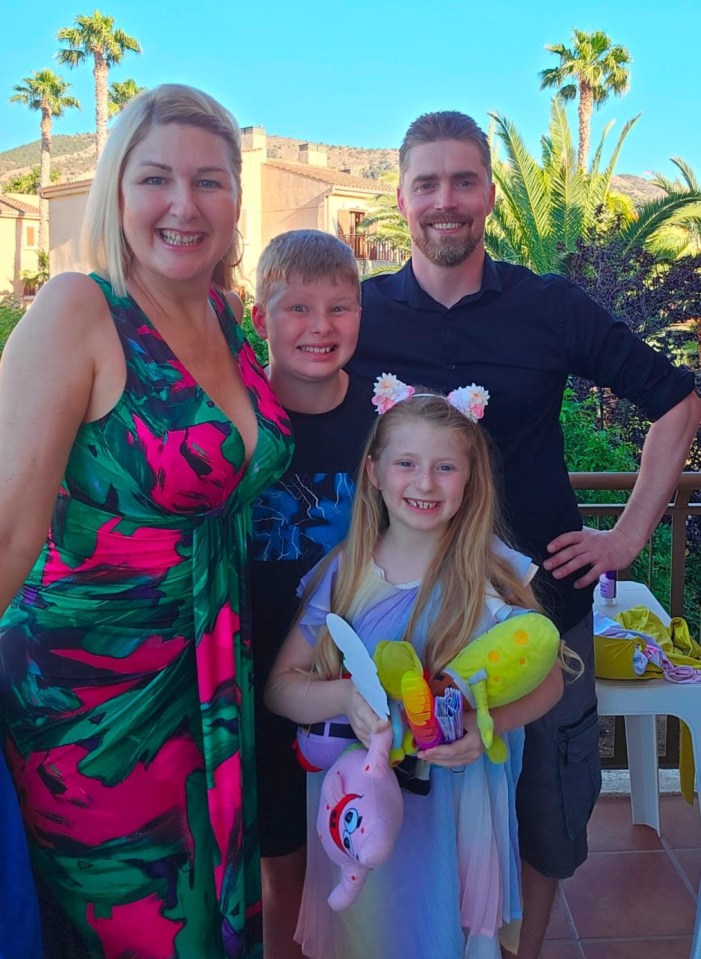 Family portrait of a mother, father, son, and daughter.