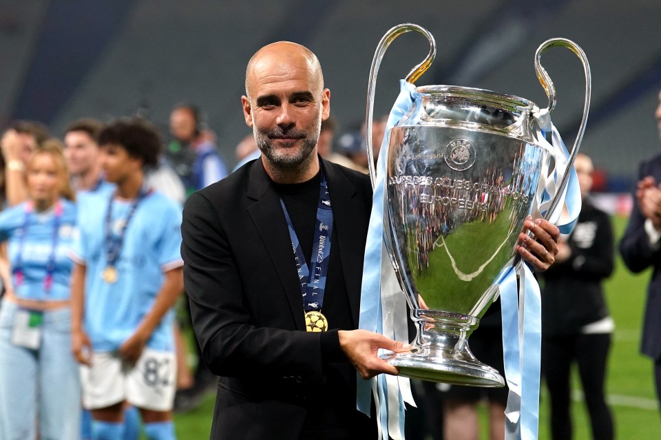 Pep Guardiola holding the UEFA Champions League trophy.