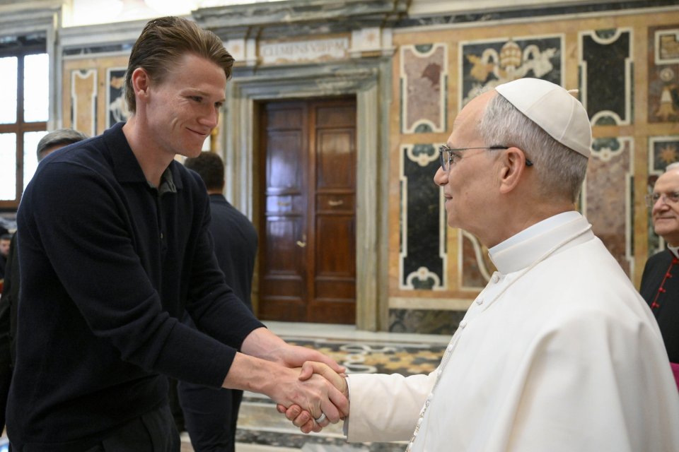 Pope Leo XIV shaking hands with FC Naples player Scott McTominay.