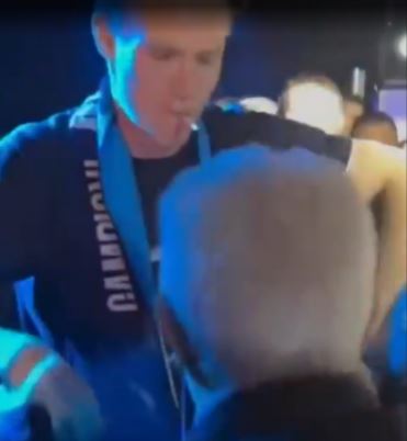 Scott McTominay dancing with an elderly fan.