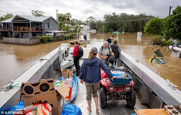 Locals in Port Macquarie are seen delivering food to isolated residents last week