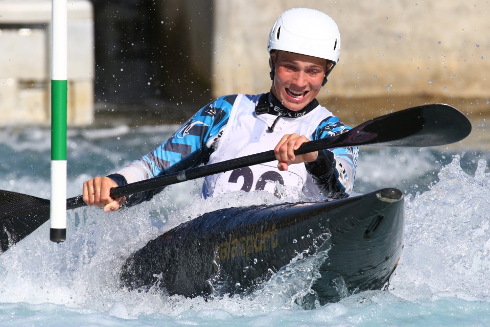 A man kayaking in a slalom canoeing competition.