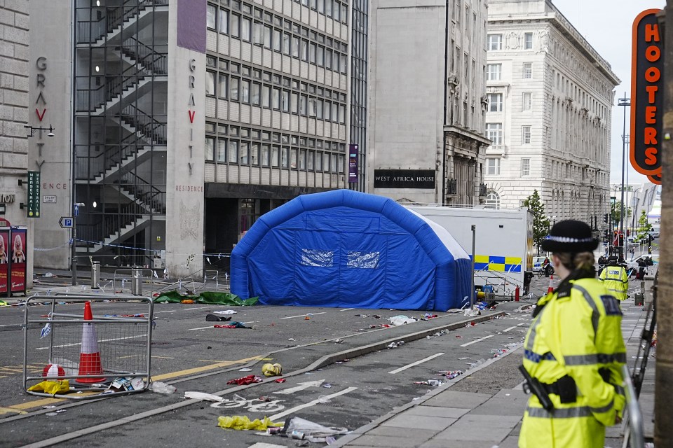 Inflatable tent and police officer at a street scene following a car crash.