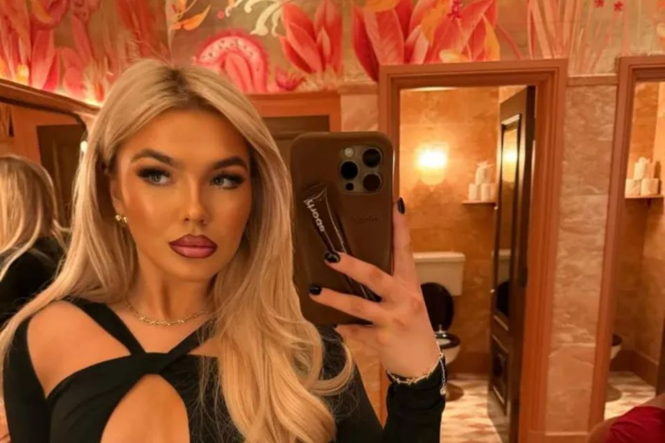 An image collage containing 1 images, Image 1 shows Woman in black cutout dress taking a selfie in a restroom