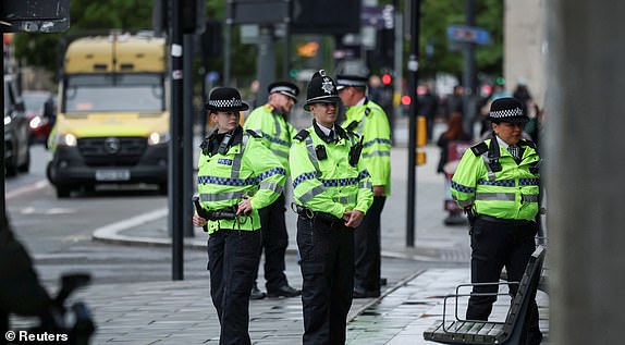 Police officers stand near the rear entrance of the Liverpool Magistrates' Court, on the day Paul Doyle, the 53-year old charged with multiple offences including dangerous driving and causing grievous bodily harm after a car drove into a crowd at Liverpool FC's trophy parade, appears at court, in Liverpool, Britain, May 30, 2025. REUTERS/Phil Noble REFILE - QUALITY REPEAT