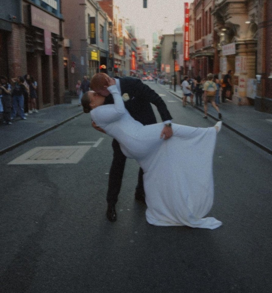 A plus-size bride and groom kissing on their wedding day.