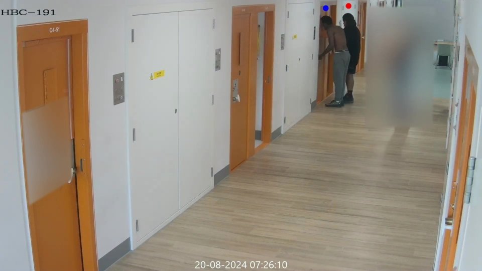 CCTV footage of a prison corridor showing two men leaving a cell after a murder.