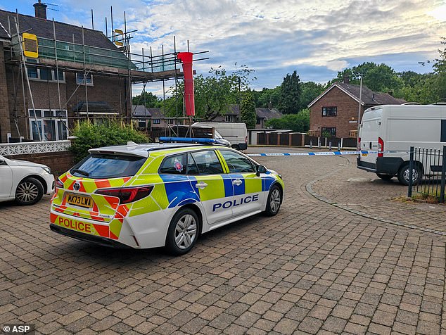 Baslow Road in Denton, which has been taped off after a baby and two adults were horribly attacked by a large dog
