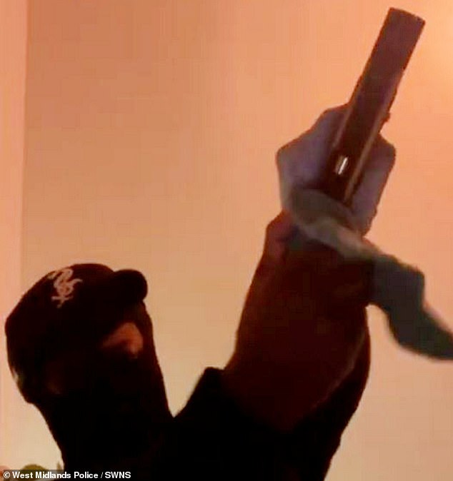 Smith is pictured here in an incriminating video unloading bullets from the pistol he possessed